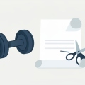 A dumbbell beside a rolled blank contract being cut by a pair of scissors