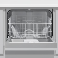 An open stainless-steel dishwasher in a modern kitchen with the lower rack pulled out