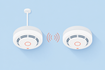 Flat illustration of two ceiling smoke alarms, one wired and one linked by wireless signal arcs