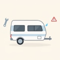 A small travel-trailer camper with a wrench, a blue water drop, and a red warning triangle nearby