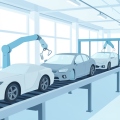 An auto assembly line with generic unbranded car bodies moving along a conveyor in a bright factory