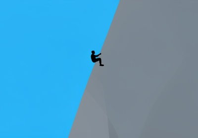 A small silhouette of a rock climber high on a tall vertical granite cliff against a blue sky