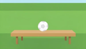 A single soccer ball resting on an empty substitutes' bench beside a green pitch
